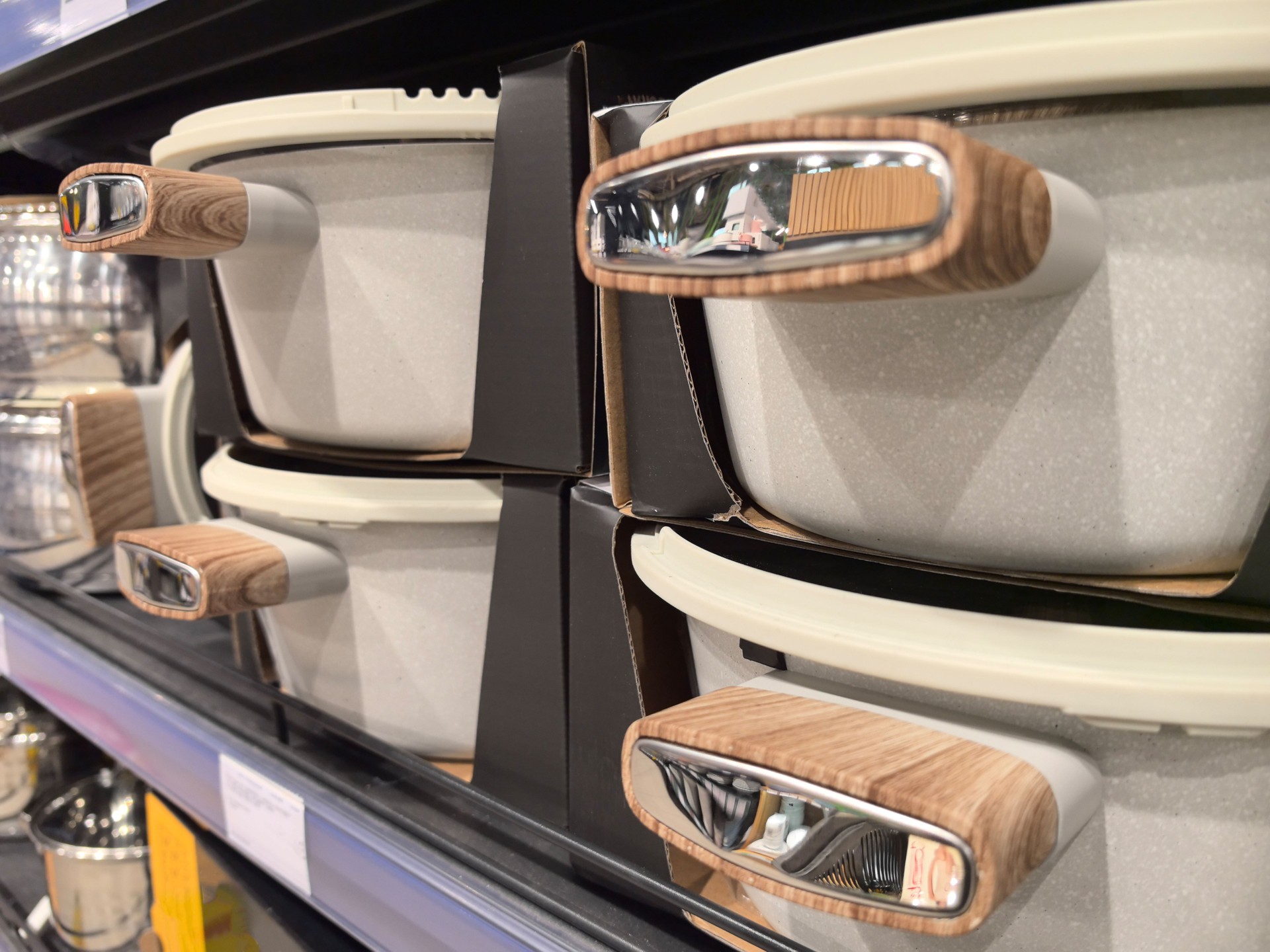 Elegant cookware displayed on shelves in a modern kitchen store setting