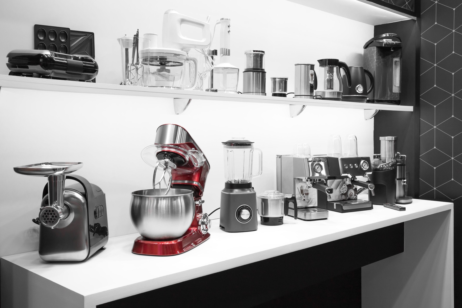 Household appliances for the kitchen. Sale of electrical equipment for cooking at home. Coffee makers, mixers, meat grinders, blenders, coffee machines, toasters and kettles on a shelf in the interior